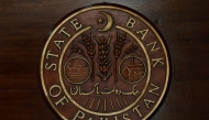 The logo of the State Bank of Pakistan (SBP) is pictured on a reception desk at the head office in Karachi, Pakistan July 16, 2019. REUTERS/Akhtar Soomro/File Photo

