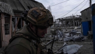 In this handout photograph taken on March 13, 2025 and released on March 14, 2025 by the press service of the 93rd Kholodnyi Yar Separate Mechanized Brigade of the Ukrainian Ground Forces, a Ukrainian serviceman stands among debris in an abandoned area in Pokrovsk, Donetsk region, amid the Russian invasion of Ukraine. (Photo by Handout / The 93rd Kholodnyi Yar Separate Mechanized Brigade / AFP) 