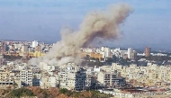 This handout picture released by the Syrian Arab News Agency (SANA) shows smoke billowing over the coastal city of Latakia after an explosion on March 15, 2025. (Photo by SANA / AFP) 