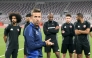 Qatar head coach Luis Garcia speaks to players during a training session.