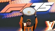 First-placed McLaren's British driver Lando Norris celebrates on the podium after the Australian Formula One Grand Prix at Albert Park Circuit in Melbourne on March 16, 2025. (Photo by Saeed KHAN / AFP)