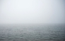 This photograph shows the sea covered in fog and dust at Palaio Faliro suburb, on the Saronic Gulf coast, south of Athens, on March 15, 2025. (Photo by Angelos TZORTZINIS / AFP)