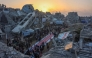 Palestinians gather for a mass fast-breaking iftar meal in front of the destroyed Salim Abu Muslim mosque in Beit Lahia in the northern Gaza Strip on March 15, 2025. (Photo by Omar Al-Qattaa / AFP)