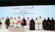 Minister of Education and Higher Education H E Lolwah bint Rashid Al Khater and QRCS President Yousef bin Ali Al Khater with other officials during the signing ceremony.