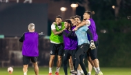 Al Sadd  players share a light moment during a training session on Sunday night.