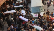 The bodies of victims killed in overnight Israeli airstrikes on the Gaza Strip are carried on stretchers at Al-Ahli Arab hospital, also known as the Baptist hospital, in Gaza City ahead of their burial on March 18, 2025. Photo by Omar AL-QATTAA / AFP