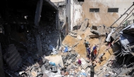 People search for survivors in the rubble of a building destroyed in an Israeli strike in Jabalia, in the northern Gaza Strip on March 18, 2025. (Photo by Bashar Taleb / AFP)
