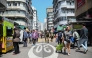 Pedestrians walk along a street in Hong Kong on March 19, 2025. (Photo by Peter PARKS / AFP)