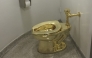 (FILES) A fully functioning solid gold toilet, made by Italian artist Maurizio Cattelan, is going into public use at the Guggenheim Museum in New York on September 15, 2016. (Photo by William EDWARDS / AFP)