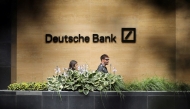 FILE PHOTO: People walk past a Deutsche Bank office in London, Britain July 8, 2019. REUTERS/Simon Dawson