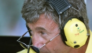 British manager Eddie Jordan looks upon his sunglasses in the pits of the Hungaroring racetrack during the first free practice session, on August 11, 2000, two days before the Hungarian Formula One Grand Prix in Budapest. Photo by Patrick HERTZOG / AFP