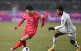 South Korea's Son Heung-min (L) competes for the ball with Oman's Abdullah Al-Harthi (R) during the World Cup 2026 Asian qualifier football match between South Korea and Oman in Goyang on March 20, 2025. (Photo by Jung Yeon-je / AFP)
 