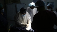 Cai Guiyang, the leader of the 22nd batch of the Chinese medical team, prepares to perform a surgery on a patient at an operating room of Edward Francis Small Teaching Hospital in Banjul, capital of Gambia, on March 12, 2025. (Xinhua/Si Yuan)
