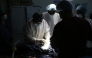 Cai Guiyang, the leader of the 22nd batch of the Chinese medical team, prepares to perform a surgery on a patient at an operating room of Edward Francis Small Teaching Hospital in Banjul, capital of Gambia, on March 12, 2025. (Xinhua/Si Yuan)
