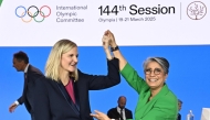 Kirsty Coventry (left) is congratulated by Moroccan former athlete Nawal El Moutawakel after being elected as the new President during the 144th IOC Session.