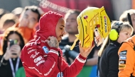 Ferrari's British driver Lewis Hamilton is seen in the pit lane after taking pole position after the sprint qualifying session of the Formula One Chinese Grand Prix at the Shanghai International Circuit in Shanghai on March 21, 2025. (Photo by Hector RETAMAL / AFP)