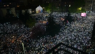 Thousands of protesters hold up their mobile phones to light up the night sky in memory of those who died in the Novi Sad roof disaster, as they take part in one of the largest anti-corruption demonstrations, in Belgrade on March 15, 2025. Photo by Andrej ISAKOVIC / AFP