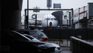 A photograph taken on March 21, 2025 shows a plane parked on the tarmac at Heathrow airport following its closure after a fire broke out at a substation supplying power of the airport, in Hayes, west London. Photo by BENJAMIN CREMEL / AFP.
