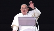 (FILES) Pope Francis waves to the crowd from the window of the apostolic palace overlooking St. Peter's square during the Angelus prayer in The Vatican on February 2, 2025. (Photo by Tiziana FABI / AFP)
