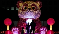 People stand in front of an illuminated giant panda decoration in celebration of the upcoming Lunar New Year in Jakarta, Indonesia, on Jan. 24, 2025. (Xinhua/Veri Sanovri)
