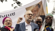 Former South African Ambassador to the United States Ebrahim Rasool (c), addresses supporters upon his arrival at the Cape Town International airport, in Cape Town, on March 23, 2025. Photo by GIANLUIGI GUERCIA / AFP.