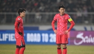 South Korea's Son Heung-min (R) and Lee Kang-in (L) prepare a free kick during the World Cup 2026 Asian qualifier football match between South Korea and Oman in Goyang on March 20, 2025. (Photo by Jung Yeon-je / AFP)
