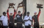 Toyota Gazoo Racing WRT's British driver Elfyn Evans (R) and co-driver Scott Martin (2nd L) hold their trophies as they pose for the media with President of Kenya William Ruto (2nd R) after winning the World Rally Championship (WRC) Safari Rally Kenya in Naivasha on March 23, 2025. (Photo by Luis TATO / AFP)
