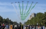 People watch as the Pakistan Air Force Karakoram-8 (K-8) aircraft team performs aerobatic manoeuvres during the national day parade as they fly past near the President's House in Islamabad on March 23, 2025. (Photo by Aamir QURESHI / AFP)
