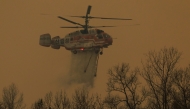 A helicopter takes part in an operation to extinguish a wildfire in Uiseong on March 24, 2025. Photo by YASUYOSHI CHIBA / AFP