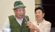 (Files) This photo taken on September 29, 2024 shows Iwao Hakamada (L) speaking as his then 91-year-old sister Hideko (R) holds the microphone during a judgement report session held by supporters in the city of Shizuoka, Shizuoka prefecture. (Photo by JIJI Press / AFP) 