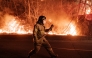 A firefighter prepares to spray water as wildfires spread along the slopes in Uiseong, South Korea, on March 24, 2025. Photo by YASUYOSHI CHIBA / AFP.