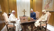 File: A handout photograph released by the Vatican press office shows Pope Francis speaking with then Britain's Prince Charles and his wife Camilla, Duchess of Cornwall, during a private audience on April 4, 2017 at the Vatican. (Photo by Osservatore Romano / AFP) 
