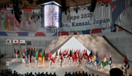 Performers parade participating countries' flags during the official opening ceremony of the 2025 Osaka Expo in the city of Osaka on April 12, 2025, a day before the event opens to the public for six months. (Photo by Philip Fong / AFP)