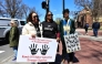 Demonstrators stand around the John Harvard Statue in Harvard Yard after a rally was held against President Donald Trump's attacks on Harvard University at Harvard University in Cambridge, Massachusetts on April 17, 2025. (Photo by Joseph Prezioso / AFP)
