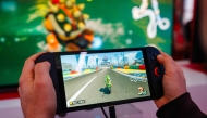 File: A guest plays Mariokart World with the new Nintendo Switch 2 video-game console system of Japanese video-game company Nintendo during the worldwide presentation at the Grand Palais in Paris on April 2, 2025. (Photo by Dimitar Dilkoff / AFP)