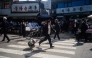 A man runs with a trolley at the Dongmyo Flea Market in Seoul on April 15, 2025. (Photo by ANTHONY WALLACE / AFP)
