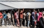 Refugees who crossed from Sudan to Ethiopia wait in line to register at IOM (International organization for Migration) in Metema, on May 4, 2023. (Photo by Amanuel Sileshi / AFP)