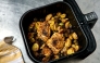File: Air fryer chicken thighs with potatoes and Brussels Sprouts. (Photo by Peggy Cormary for The Washington Post)