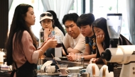 A staff member pouring coffee for guests at the Xiaowazi, or Little Hollow, coffee plantation in Pu'er. (Photo by Greg Baker / AFP) 