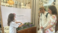 A student displays her project during the Earthna Summit.