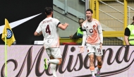 Roma's Argentinian forward #18 Matias Soule (R) celebrates with a teammate after scoring his team first goal during the Italian Serie A football match between Inter Milan and Roma at the San Siro stadium in Milan on April 27, 2025. (Photo by Piero CRUCIATTI / AFP)