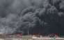 A handout picture provided by the Iranian Red Crescent (IRCS) on April 28, 2025, shows thick black smoke billowing at the scene of a massive explosion two days earlier at the Shahid Rajaee port dock southwest of Bandar Abbas in the Iranian province of Hormozgan. Photo by Iranian Red Crescent / AFP