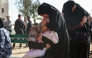 A Palestinian woman comforts another holding the body of her baby, killed in Israeli strikes on the the Abou Mahadi family home in Beit Lahia, outside the Indonesian Hospital in the northern Gaza Strip on APril 28, 2025. (Photo by BASHAR TALEB / AFP)
