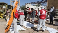 Yemeni rescuers transport the bodies of victims pulled from the rubble of a building hit in US strikes in the northern province of Saada on April 28, 2025.