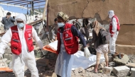 Yemeni rescuers transport the body of a victim from the rubble of a building hit in US strikes in the northern province of Saada on April 28, 2025. (Photo by AFP)