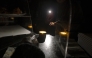 A waiter gives change by the light of her phone in a bar during a massive power cut affecting the entire Iberian peninsula and the south of France, in Hernani on April 28, 2025. (Photo by ANDER GILLENEA / AFP)
