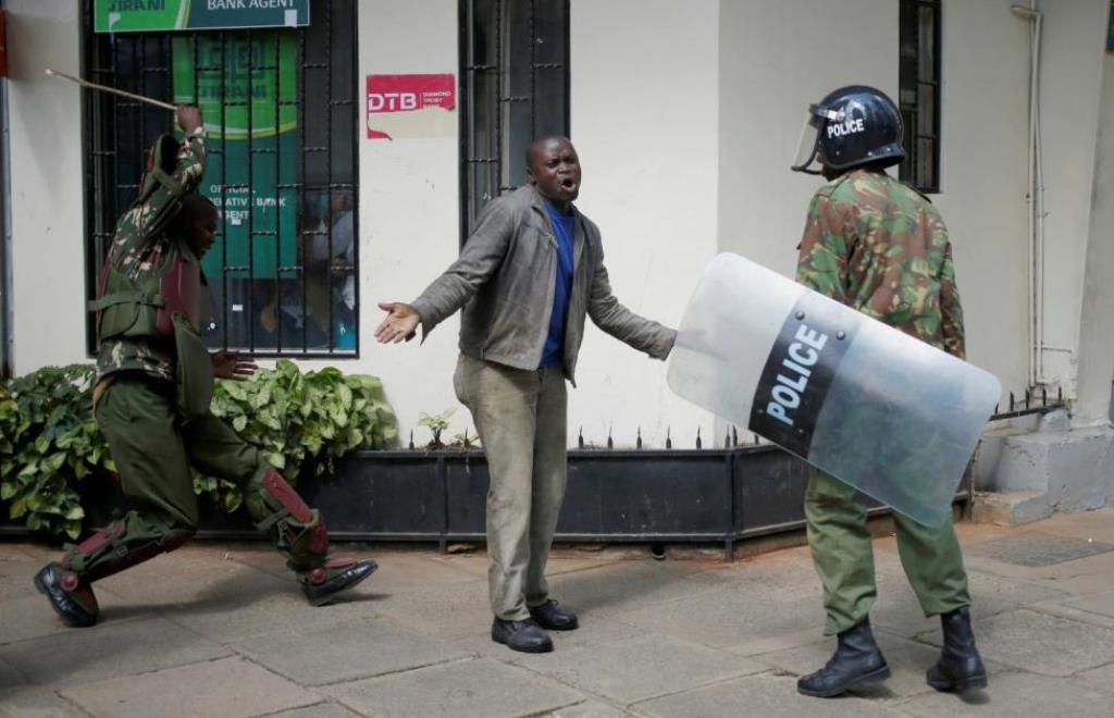 Kenyan policemen beat a protester during clashes in Nairobi, Kenya May 16, 2016. REUTERS/Goran Tomasevic