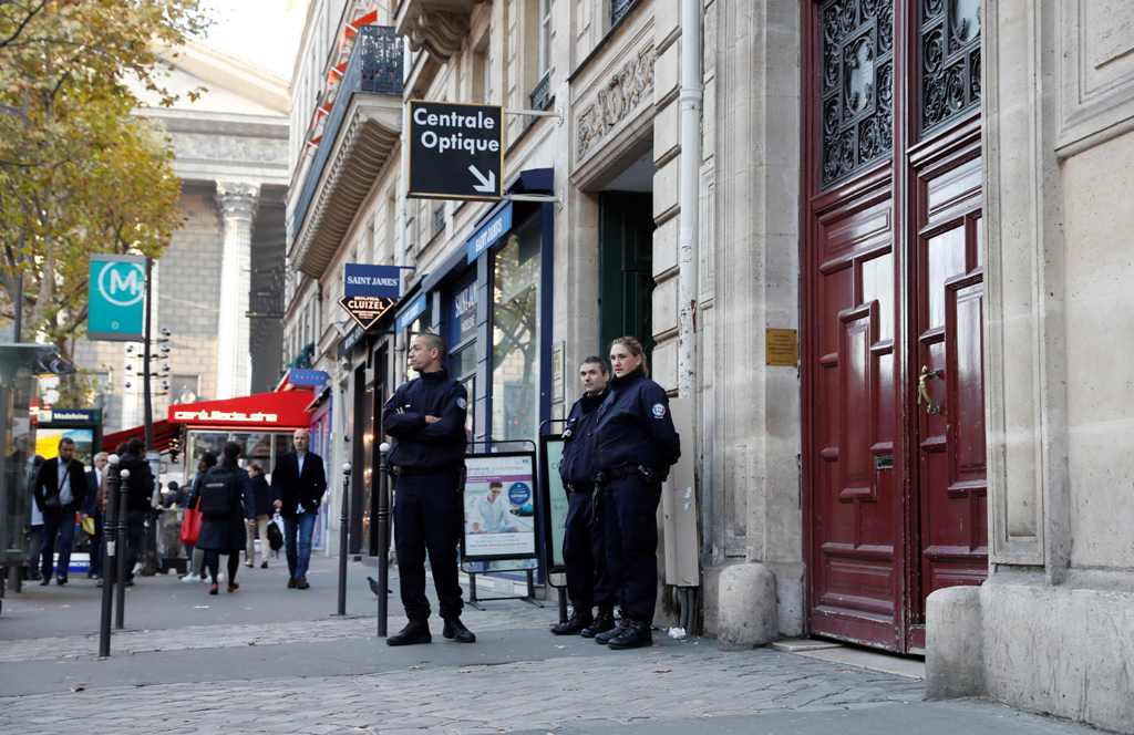 (FILES) This file photo taken on October 03, 2016 shows police officers standing guard at the entrance to a hotel residence at the Rue Tronchet, near Madeleine, central Paris, where US reality television star Kim Kardashian was robbed at gunpoint by assai