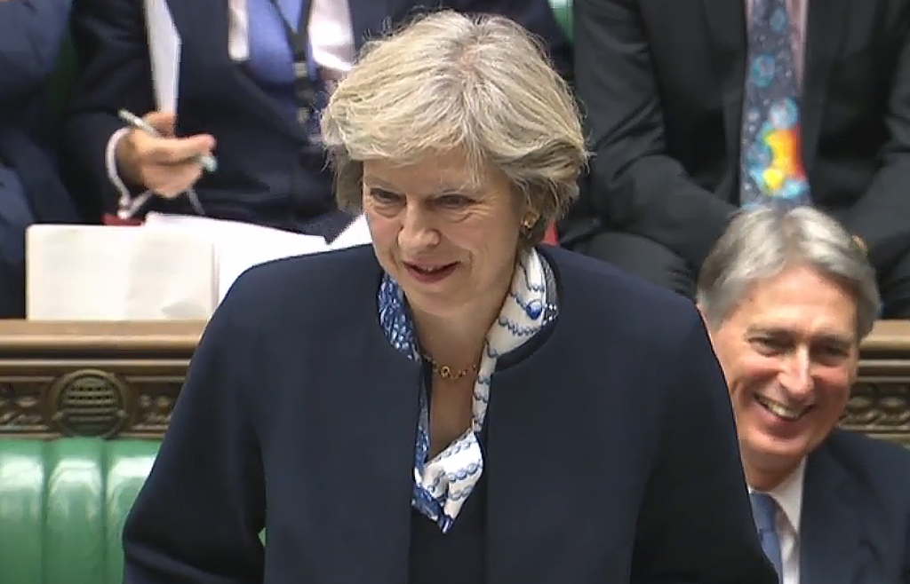 A video grab from footage broadcast by the UK Parliament's Parliamentary Recording Unit (PRU) shows British Prime Minister Theresa May as she speaks during Prime Minister's Questions (PMQs) in the House of Commons in London on October 12, 2016.  AFP 