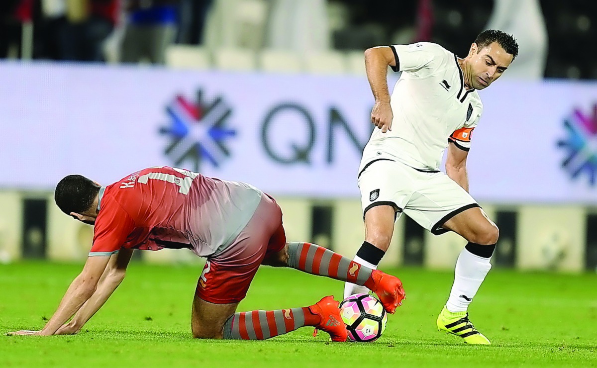 Al Sadd's captain Xavi Hernandez (right) vies for the ball against a Lekhwiya player during their Qatar Stars League match played at Jassim bin Hamad Stadium yesterday. Lekhwiya won 2-1 to stay on top of the points table.